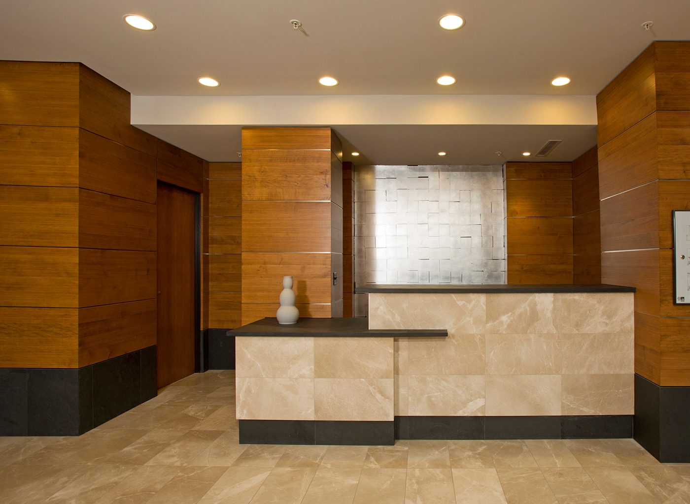 Reception desk with tiles and wood panelling on walls