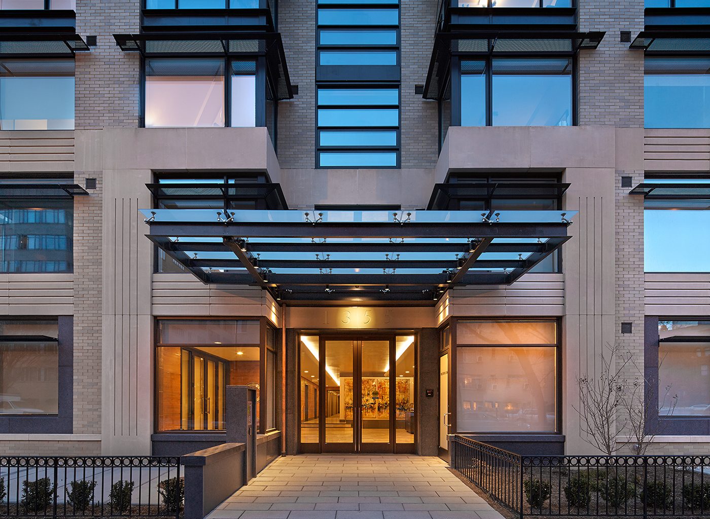 Entrance to modernist building, brightly lit from within