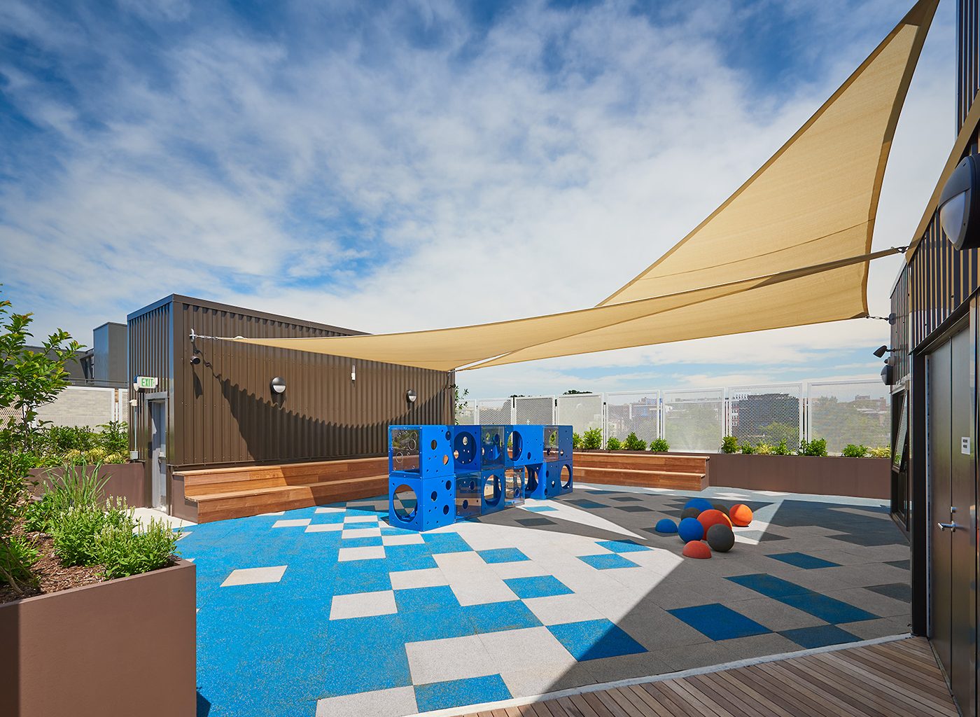 Rooftop area of apartment building with balls and screen from sun