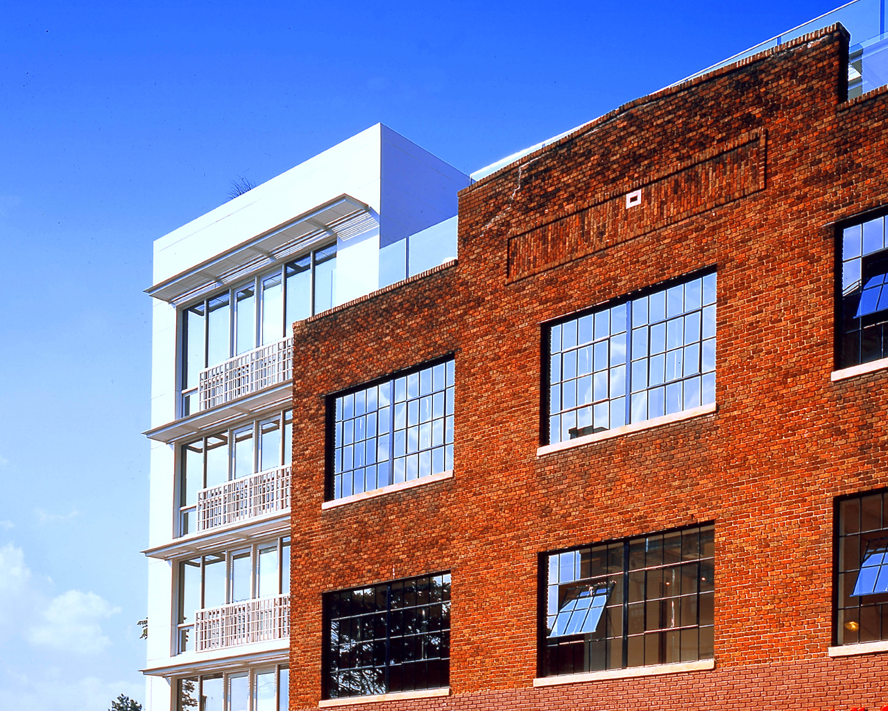 Brick exterior of Rainbow lofts in sunlight