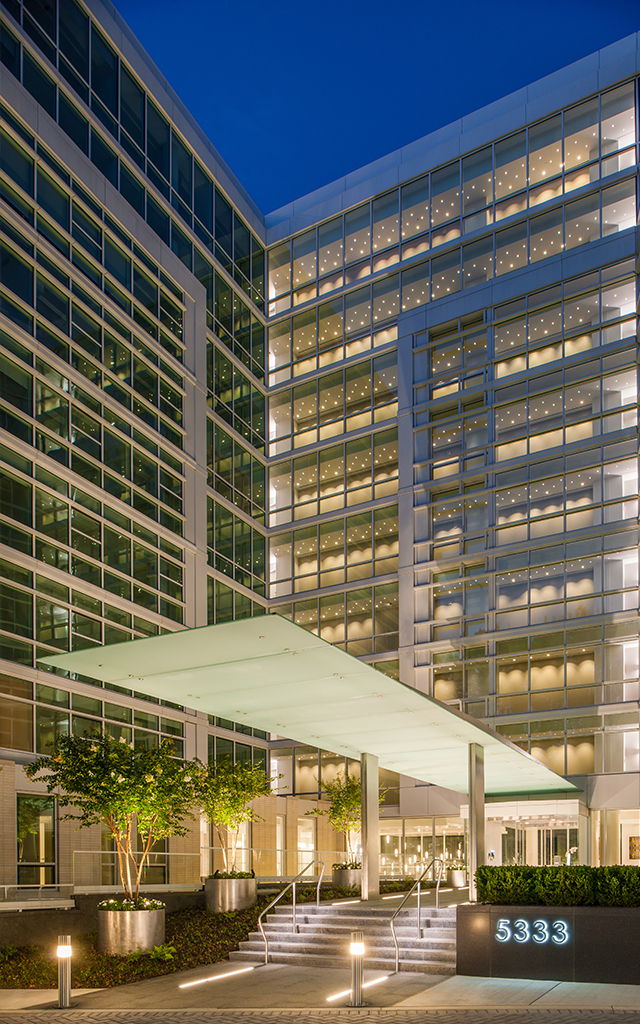 Modernist building brightly lit from within at night