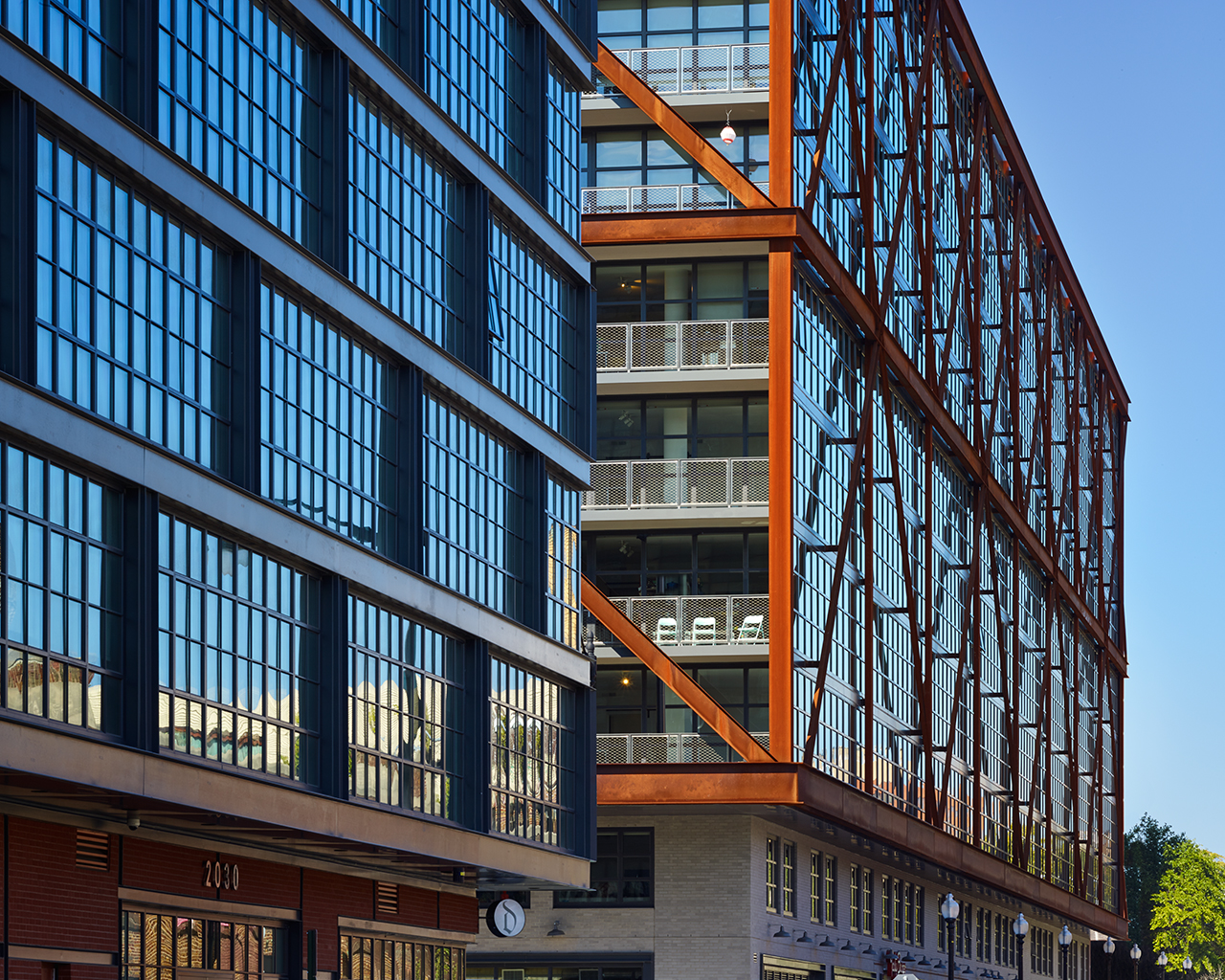 Exterior of bright, reflective building with iron accents