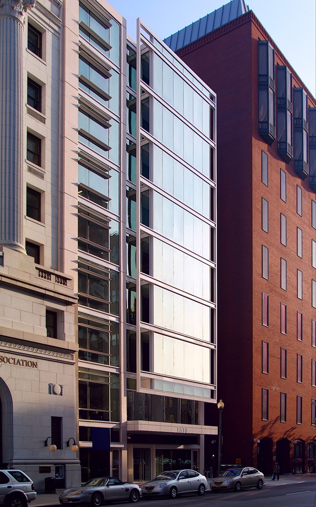 Glass exterior of tall building at sunrise