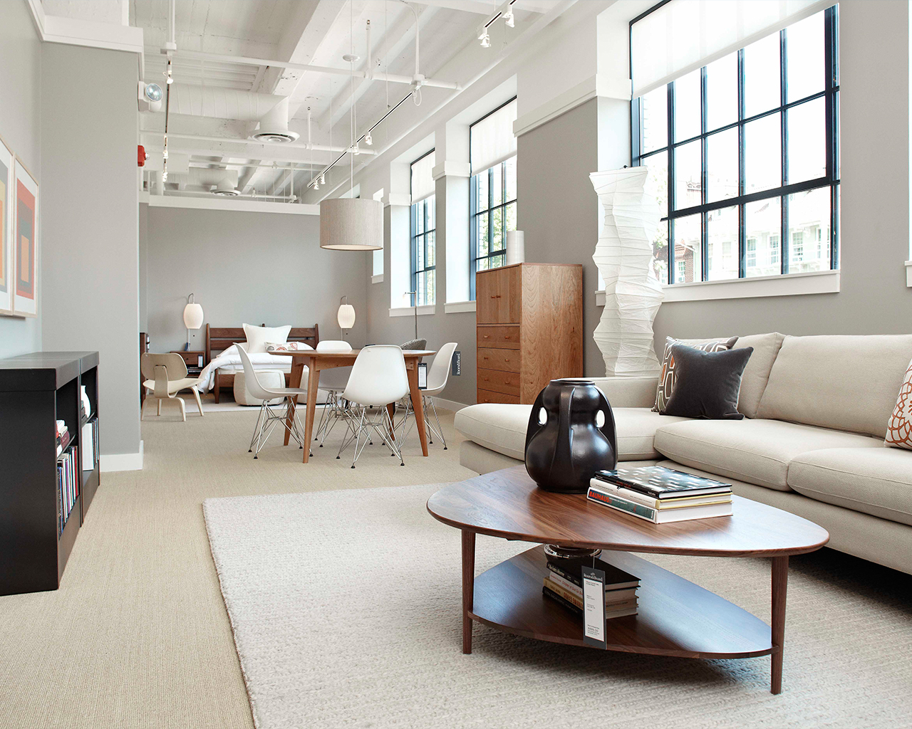 Brightly lit living room with white modernist furniture