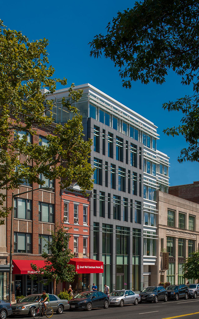 Exterior view of tall building on busy DC street