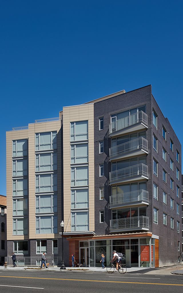 Rendering of tall building on busy city street