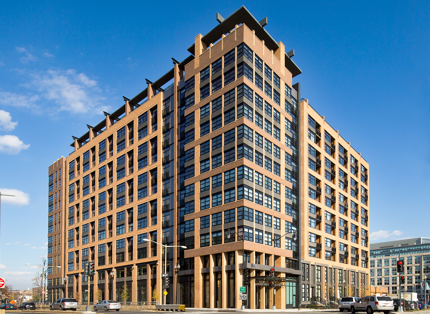 Rendering of tall building on busy city street seen from an angle