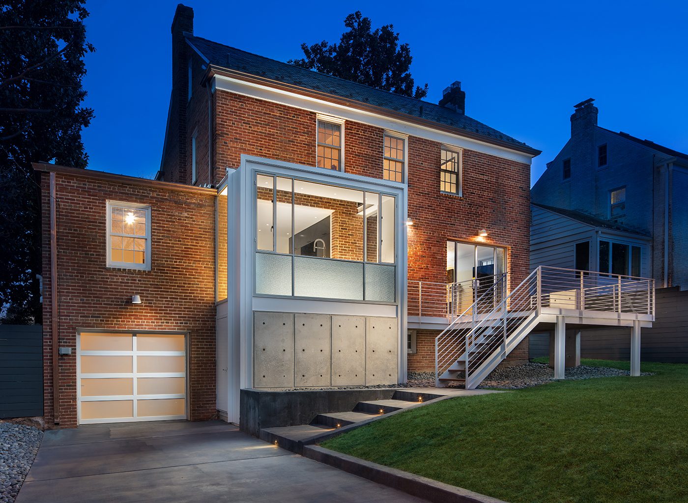 VIew of stately brick house with modern kitchen attached