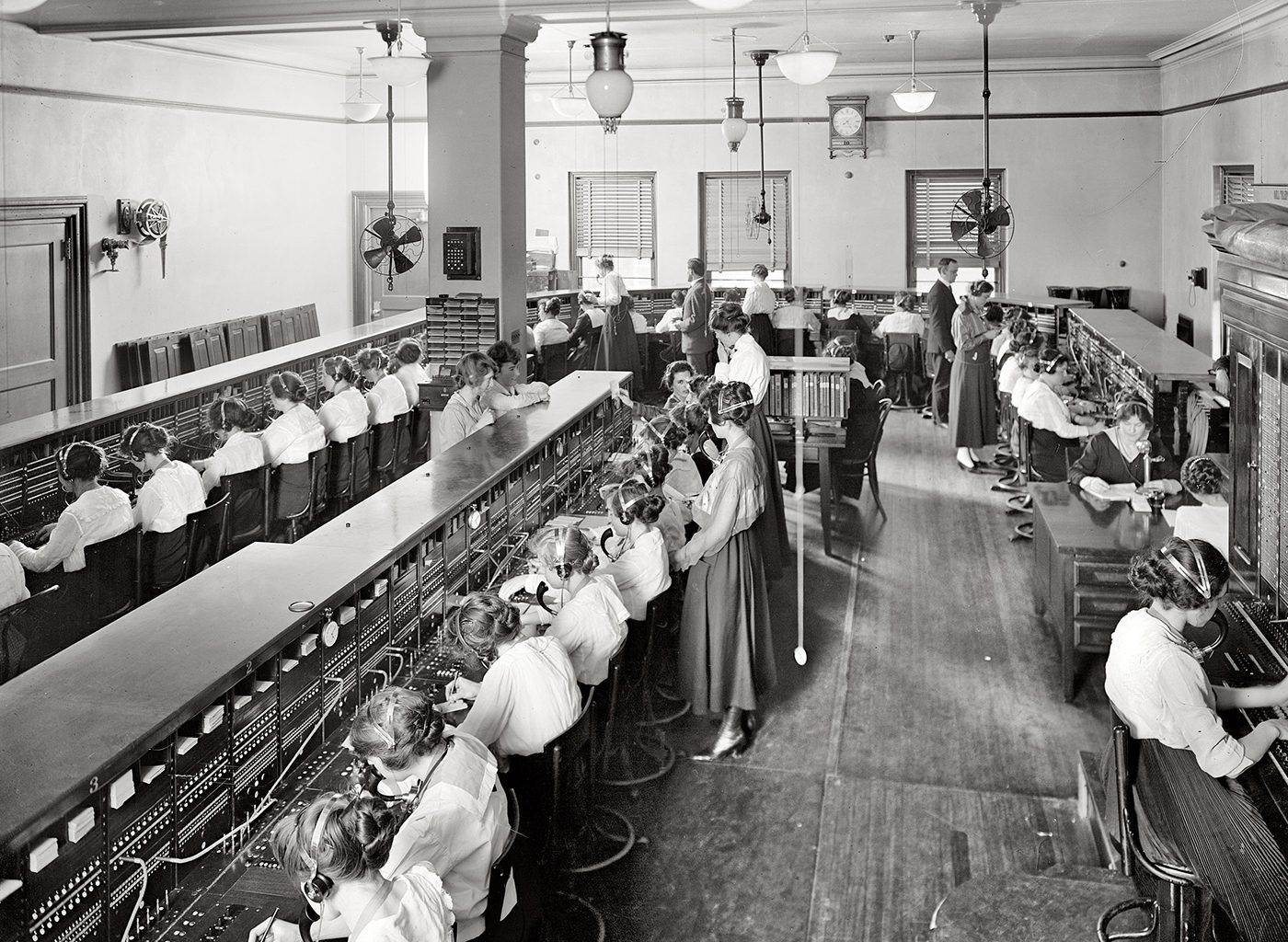 Early photo of women working at telephone machines