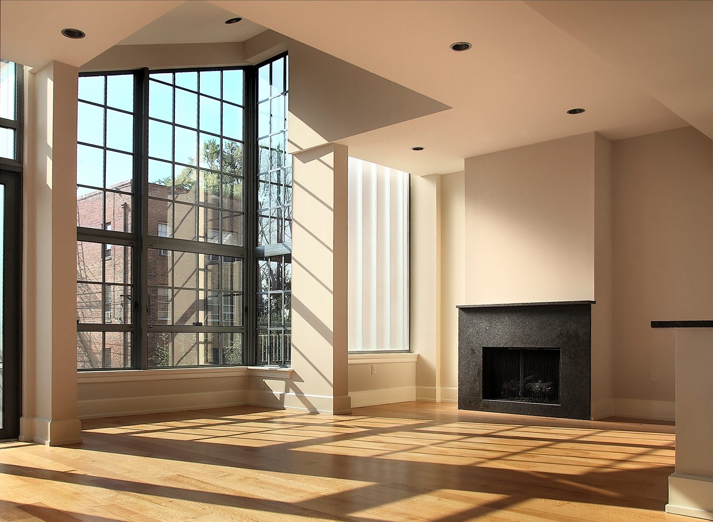 Open interior of unfurnished apartment with fireplace