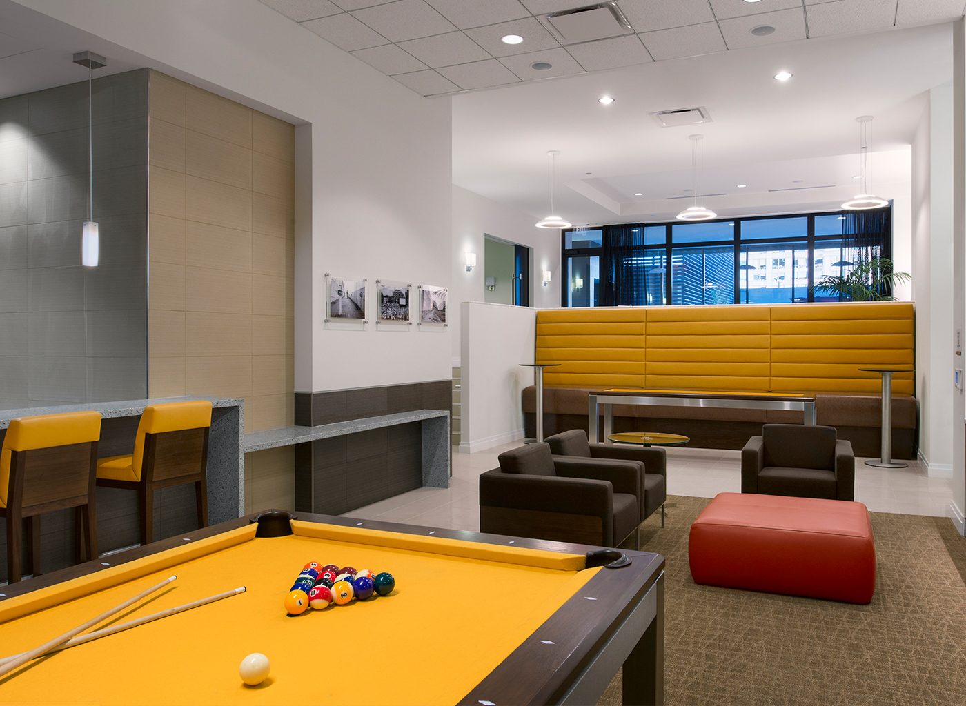 Interior game room of apartment complex with pool table and lounges