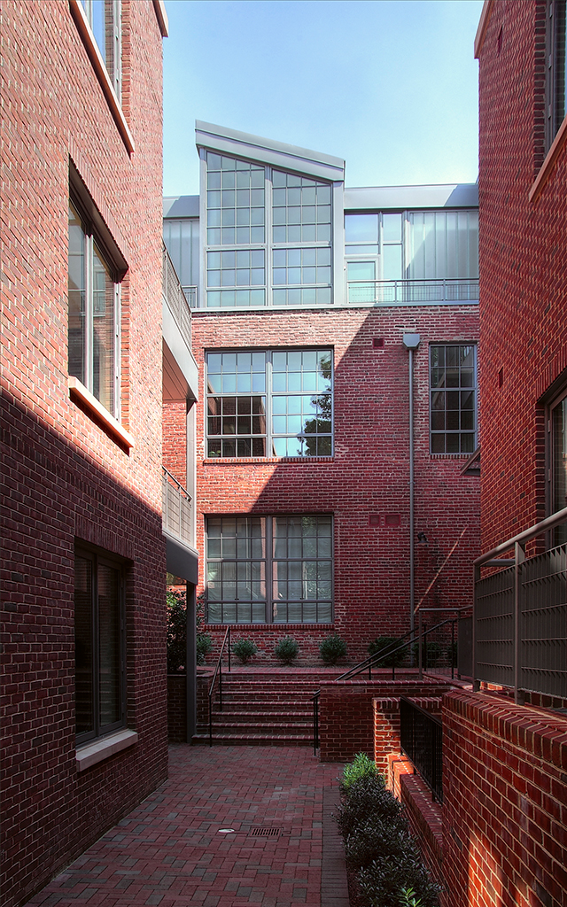 Courtyard of brick building with bushes